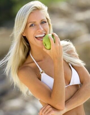فتاة تأكل تفاحة لانقاص وزنها بمقدار 10 كجم شهريا